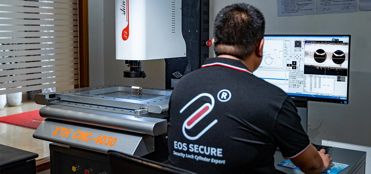 inspector checking the measurements of a lock cylinder using a digital microscope