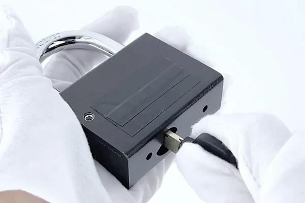 black padlock and key fitting